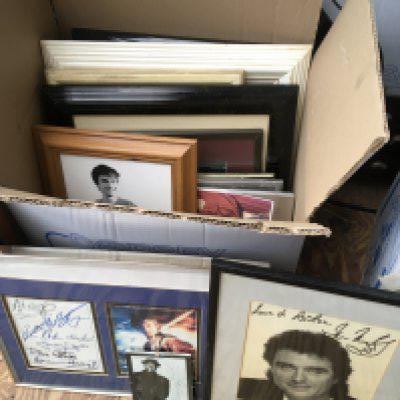 A box of framed and signed publicity prints of various actors and musicians, mostly printed. Please note that buyers must satisfy themselves as to the authenticity of any signed items before bidding as we are not experts in this field and will not be held responsible should they prove to be anything other than genuine.