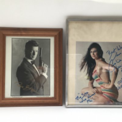 A framed and signed photo of Pierce Brosnan and one of Bond girl Caroline Munro (2). No COAs. Please note that buyers must satisfy themselves as to the authenticity of any signed items before bidding as we are not experts in this field and will not be held responsible should they prove to be anything other than genuine.