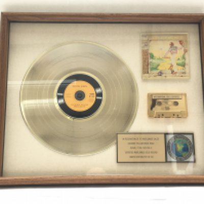 A framed and glazed limited edition gold disc, CD and cassette display in recognition for worldwide sales of the Goodbye Yellow Brick Road album by Elton John. Number 22/60. Approx 53cm x 43cm.