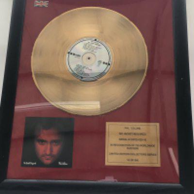 A framed and glazed limited edition gold disc and CD display in recognition for worldwide sales of the No Jacket Required album by Phil Collins. Number 10/500. Approx 46cm x 56cm.