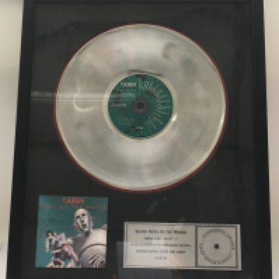 A framed and glazed limited edition platinum disc and CD display in recognition for worldwide sales of the News Of The World album by Queen. Number 17/50. Approx 53cm x 43cm.