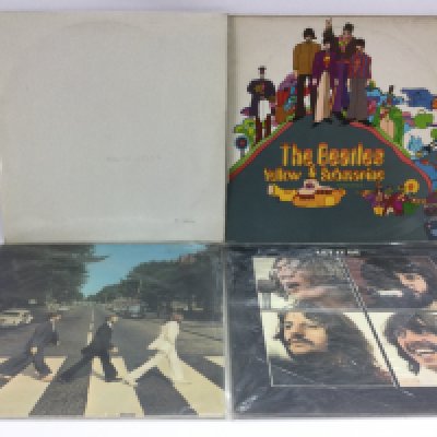 Four Beatles LPs comprising a side opening and numbered 'White Album' stereo pressing, 'Yellow Submarine', 'Abbey Road' and 'Let It Be'.