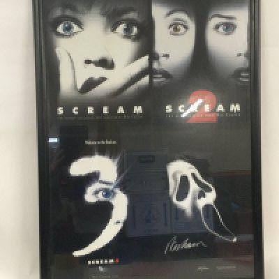 A framed and glazed limited edition Wes Craven signed poster for the Scream trilogy of movies.