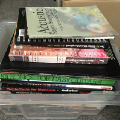 A box of music tuition books.