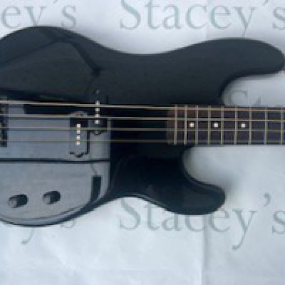 A 2002 Fender Japan Aerodyne Precision Bass Guitar in black with gold decal. This bass is in nearmint unplayed condition with shrink wrap still on control cavity cover. Comes with original Fender indent case.