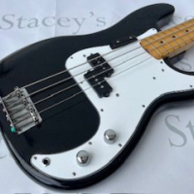 A 1974 Fender USA Precision Bass Guitar in black. Body only refinish with nice patina. Changed pick guard and controls. Original pickups and pots and internals have been checked. Wear to back exposes grey primer, nice patina to body so early refinish. Tarnishing to brightwork. Very light wear to frets. Comes with non original case.
