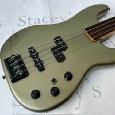 A 1989 Fender Japan Fretless Jazz Bass Guitar in Jade Pearl Metallic - some playwear and light marking consistent with age and use. Light edge wear to headstock. All original parts. Comes with non original Case