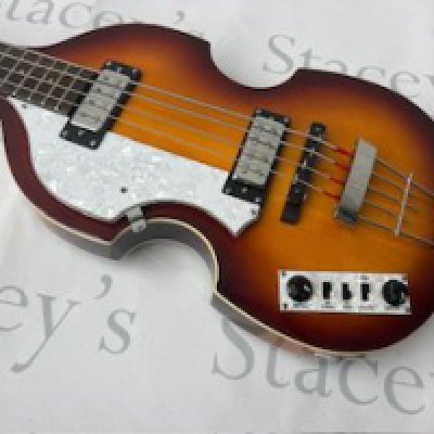 A Hofner B-Bass "Beatle Style" Hi Series Bass Guitar in sunburst finish. Very good unplayed condition with stickers still on rear of headstock. All original parts and comes with an original shaped case. Still in store setup and would benefit from being set up to the new owner's specifications.