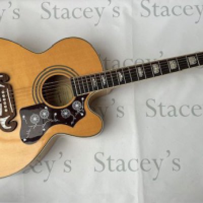 An Epiphone EJ 200 Electro-Acoustic Guitar with built in pickup and Epiphone Sonic 2 system. Come with gold plated parts and in very good + condition. Very light playwear and fret-wear. Comes with gig bag.