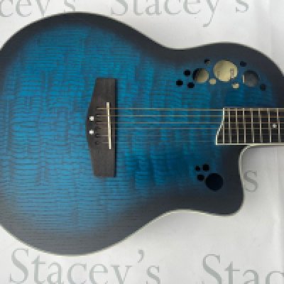 A Gear4Music RB230B Roundback Acoustic Guitar in New Unplayed condition. Transparent blue top with darkwood fingerboard. With built in Belcat OV3T Tuner and Preamp. Plastic still on Truss rod cover and Tuner. No Case