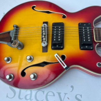 1970s Lawsuit era Commodore no. 25 semi-hollow body electric guitar, made in Japan; Body: cherry sunburst finish, minor dings and scratches crack to nut and some loss of nut on 6 string side; Neck: good;; Frets: average; Electrics: working; Hardware: generally good, missing trem arm and pick guard.