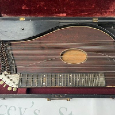 A late Victorian Blackwood Autoharp in wooden case with brass lock and handle. Requires restringing. All accessories in place and etched tuner surround shows light tarnishing consistent with age and use.
