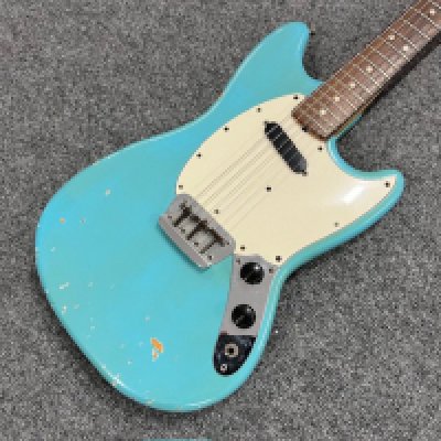 A late 1960's, most likely 1969 Fender Music Master II model in all original Daphne Blue paint and all original parts except for changed neck plate. Extensive playwear. Comes with a non original case.