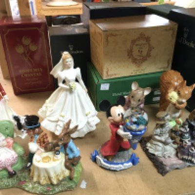 A collection of porcelain and other figures including Doulton , Disney , The Boyds, Beswick figures etc. this lot cannot be posted