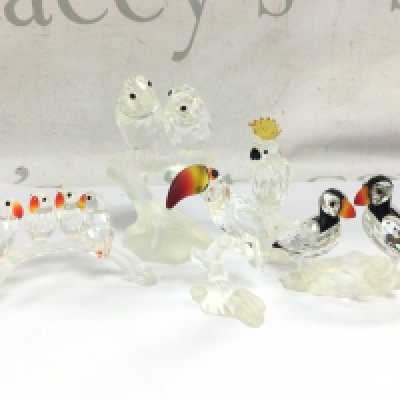 A collection of Swarovski crystal glass figures including Love Birds, Toucan, Puffins etc . This lot cannot be posted