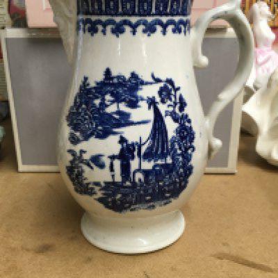 A Liverpool blue and white jug decorated in the fisherman pattern.