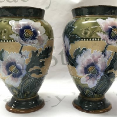 A pair of Doulton Lambeth vases , marked to the base . 21cm tall. This lot cannot be posted