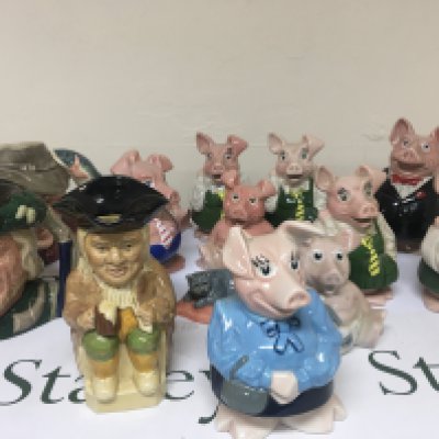 A collection of NatWest Pig money boxes Doulton caricature jugs and other ceramics.