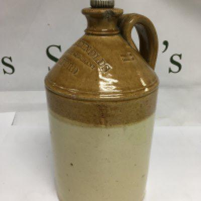 A Doulton Lambeth stoneware bottle marked Peter Reynolds Wine & Spirit Merchant, Romford. Shipping category D.
