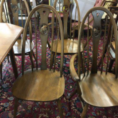 A mid century teak extending dining table and four swan back ercole chairs. Dining table dimensions 148x92cm.