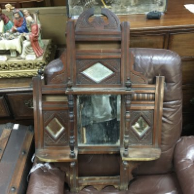 A small over mantle oak carved design mirror , 57cm wide 82cm tall approximately
