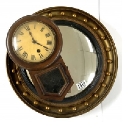 A 1930s gilt convex wall mirror together with a small wall clock.
