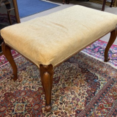 A 20th Century upholstered walnut stool.