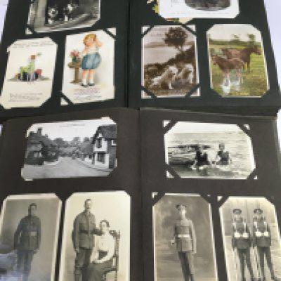 Two postcard albums including military, Mabel Lucie Atwell and others.