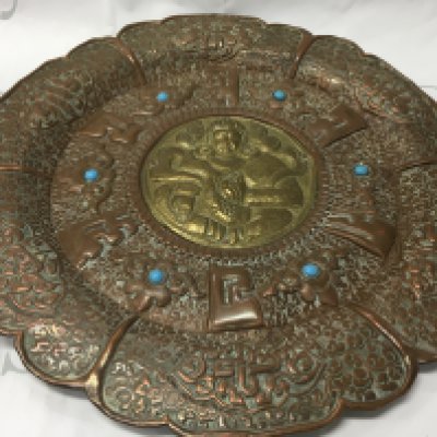 A Tibetan bodhisattva wall plaque inset with turquoise. Diameter 35cm.