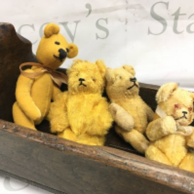 Four vintage miniature jointed teddy bears in an old hardwood rocker, signed on one foot. Postage category b