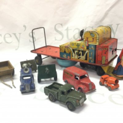 A collection of vintage toys including a tin plate Mr Porter and luggage , various play worn dinky toys . Postage cat B