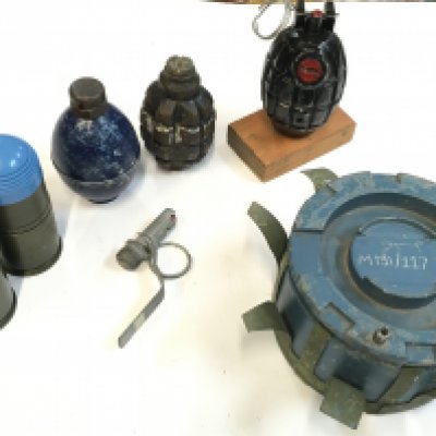 A Mills hand grenade , American anti personnel land mine with two training hand grenades , one Russian two practise rounds. This lot cannot be posted
