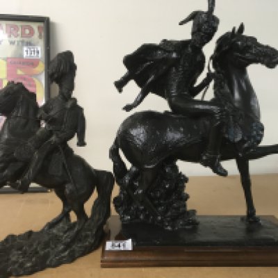 A figure in the form of a Hussar cavalry officer on horseback together with One other figure on horseback on a plinth base .