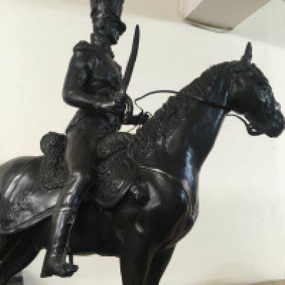 A bronzed model in the form of a Prussian Hussar on a marble base . 53 cm .