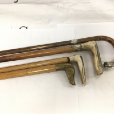 Four walking sticks including two with silver bands. Shipping category D.