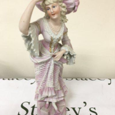 A Victorian Continental figure of a young girl in traditional dress Hight 44cm