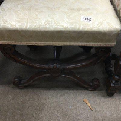 A Victorian mahogany X framed stool on carved legs .