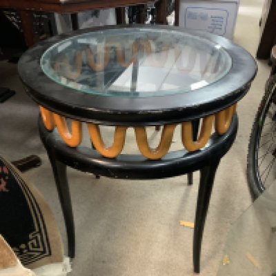 A small ebonized glass topped coffee table. 59cm x 61cm