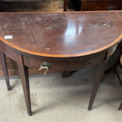A Georgian demi lune folding table. 91cm x 74cm