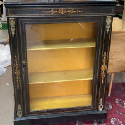 An Edwardian ebonized and inlaid pier cabinet with gilt metal mounts.75cm x 102cm x 31cm