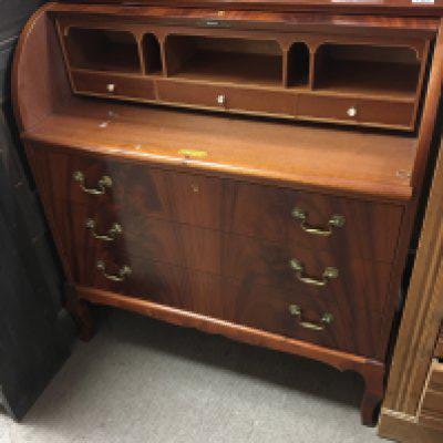 A Mahogany cylinder bureau with a solid roll top fitted interior above three drawers. 90cm wide. NO RESERVE