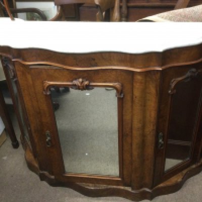 A Victorian walnut marble topped credenza with mirrored doors, approx 121cm x 37cm x 85cm. Shipping category D.