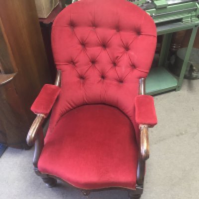 A Victorian open armchair with red upholstery.- NO RESERVE