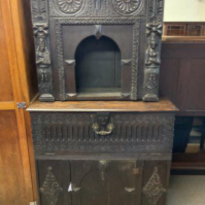An antique gothic carved oak court style cabinet profusely carved front and side.175cm x 93cm.