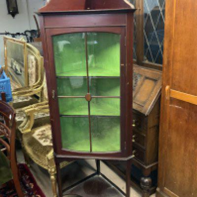 An Edwardian corner display cabinet.