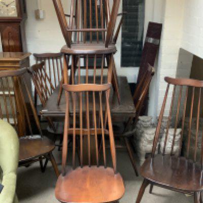 10 Ercole stick back dining chairs together with a small draw leaf table.