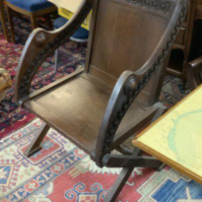 An Antique carved oak Glastonbury chair.