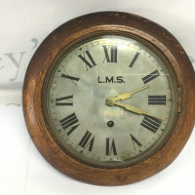 An LMS wall clock, approx diameter 28cm. Shipping category D.