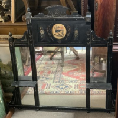 A Victorian ebonized and hand painted over mantle mirror. 107cm x 100cm.