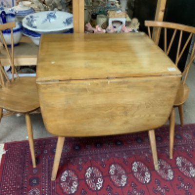 Mid Century Blonde Ercol Windsor Plank Drop Leaf-Dining Table Together with a pair of Ercol Elm Chiltern candlestick dining chairs.